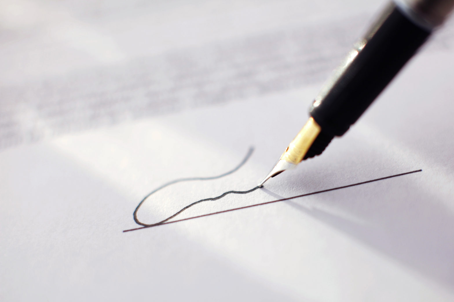 A pen signing a document